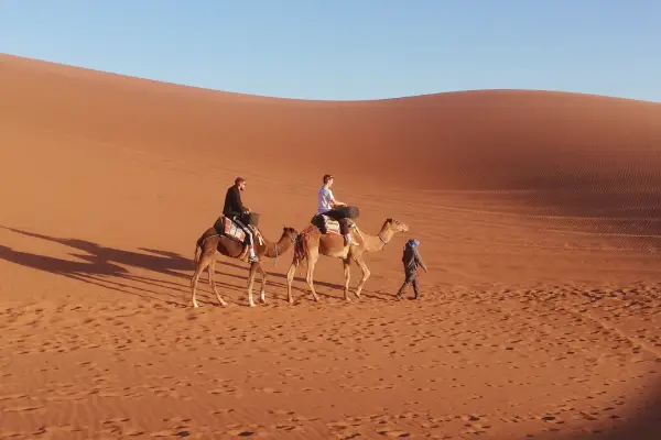 camel ride in Chegaga desert dunes Morocco